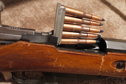Clip inserted into top of a rifle