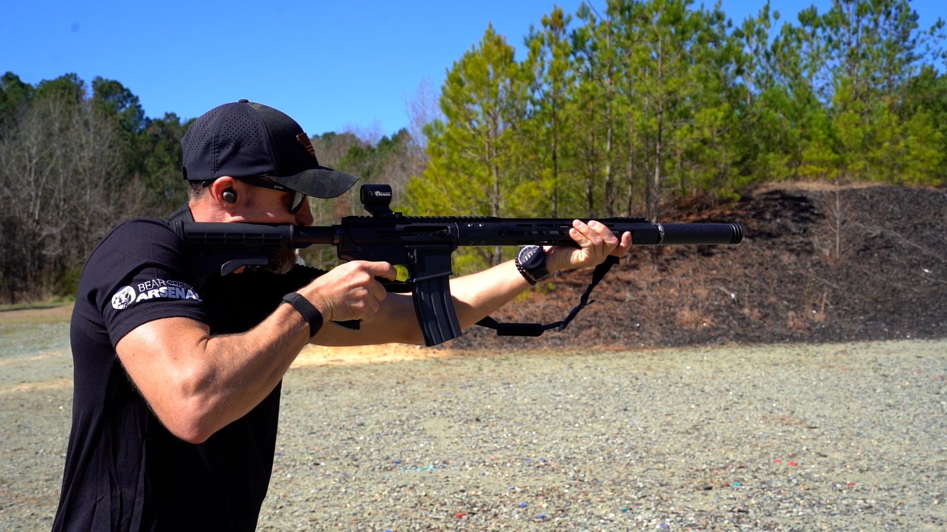 Guy holding AR-15 with Silencer attached