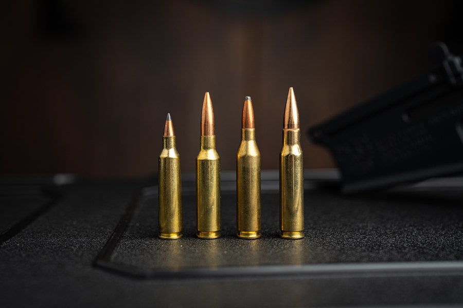 .22-250, 6.5 Creedmoor, .243 Winchester, and .308 Winchester bullets comparison on table