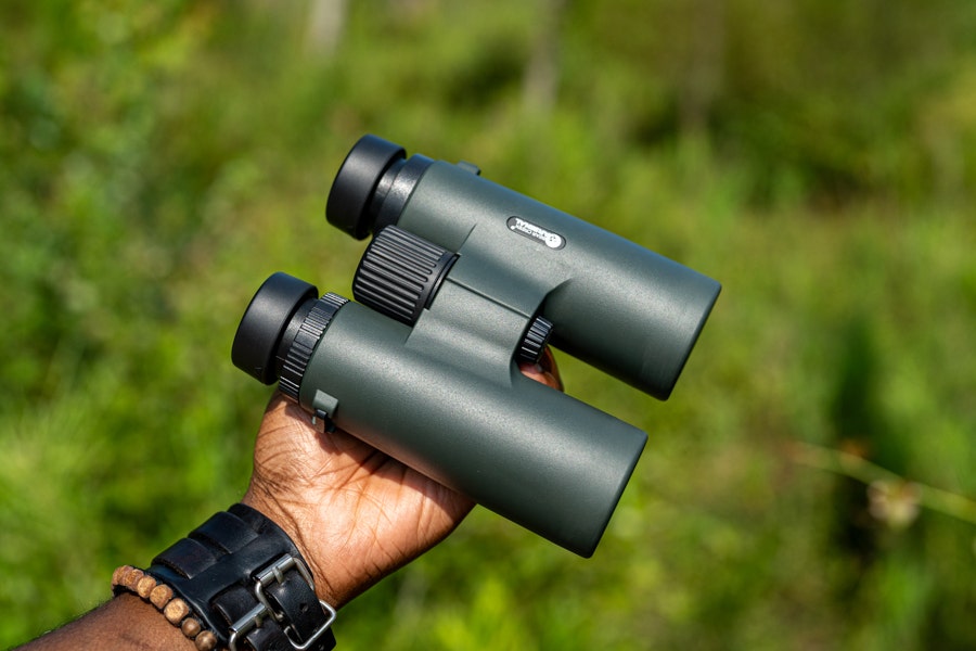 Holding a pair of binoculars